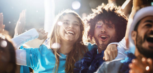 istock Couple cheering at a live soccer match. 1204653147