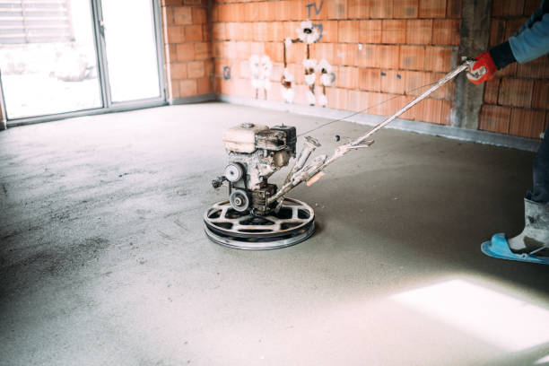 istock Construction industrial worker finishes concrete screed with trowel machine 1204653428