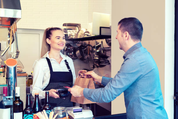 istock Customer paying to go order with credit card in small eatery 1204653477