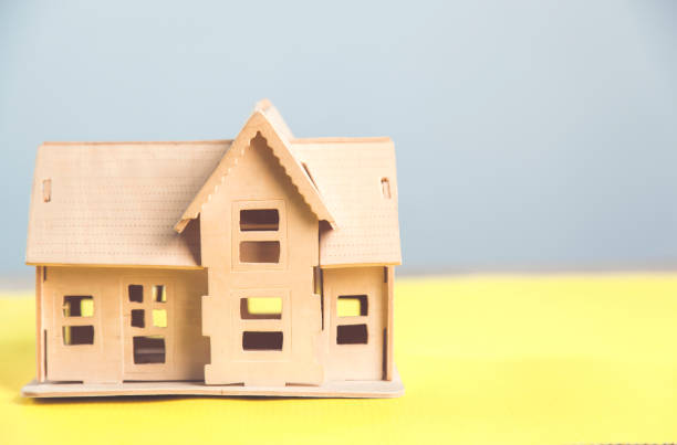 istock wooden house on  table 1204655420