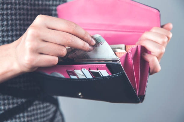 istock woman hand money with wallet 1204655520