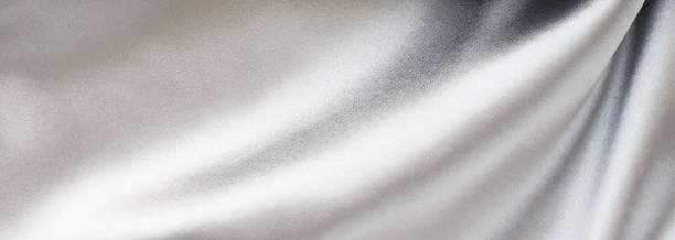 istock Silk fabric texture pastel silver color banner background. Beautiful soft crumpled silk wedding background.Copy space 1204656059