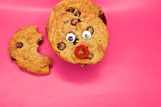 istock Funny Face Chocolate Chip Cookies against Pink background 1204656168