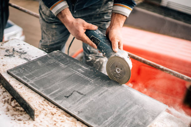 istock Construction site details - industrial tool, worker with angle grinder cutting marble and granite stone 1204657048