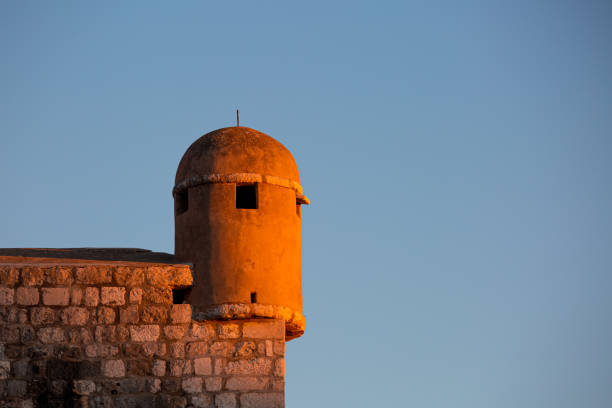 old medieval brick tower inside fort of Dubrovnik ancient walls at golden hour