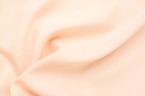 istock Silk fabric texture pastel pink color. Beautiful soft crumpled pink silk wedding background.Copy space 1204657959