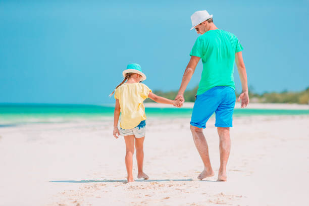 istock Little girl and happy dad having fun during beach vacation 1204658948
