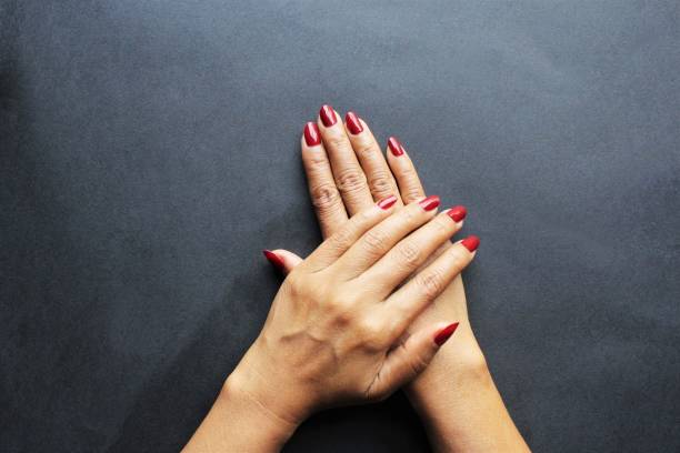 istock Women hands red nail polish photo 1204659910