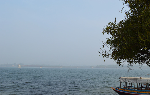 boat sailing approach at the beautiful blue Kangsabati lake of Mukutmanipur, Bankura,West Bengal India with blue sky white cloud.