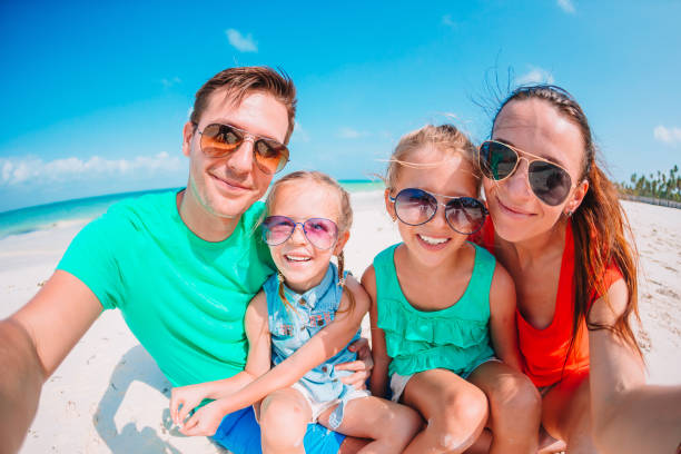 istock Happy beautiful family on white beach having fun 1204660198