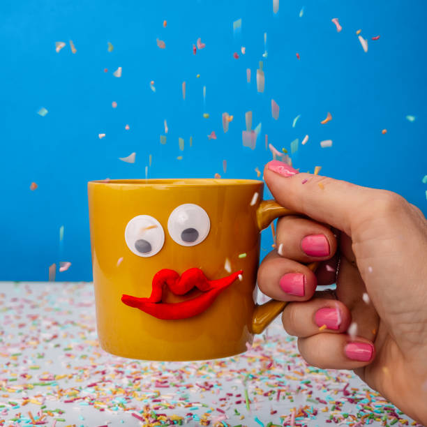 istock Coffee cup with happy face and sprinkles 1204661110
