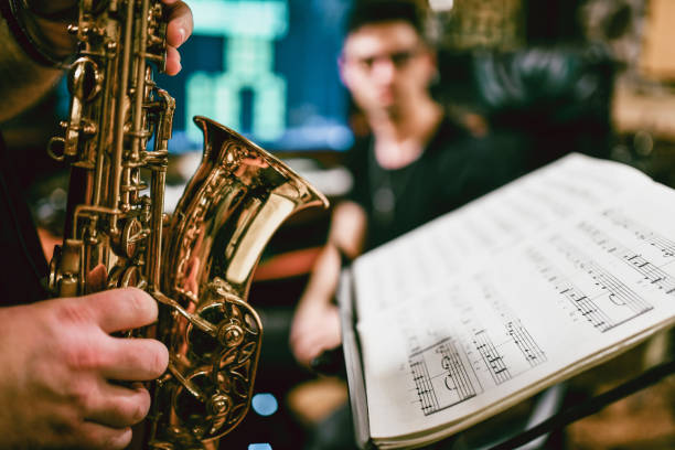 istock Sax Player Playing His Parts Written In Sheet Music 1204662765