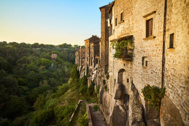 Landscape and panorama at sunset of the ancient medieval village of Vitorchiano in the province of Viterbo, with woods and old houses with stone brick walls stock photo