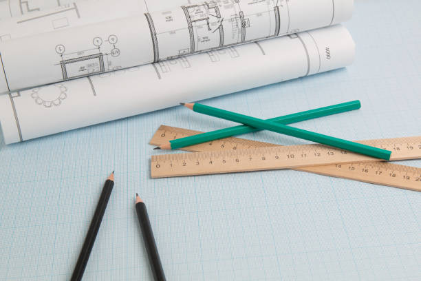 istock pencils, blueprint drawings end engineering ruler on graph paper 1204666150