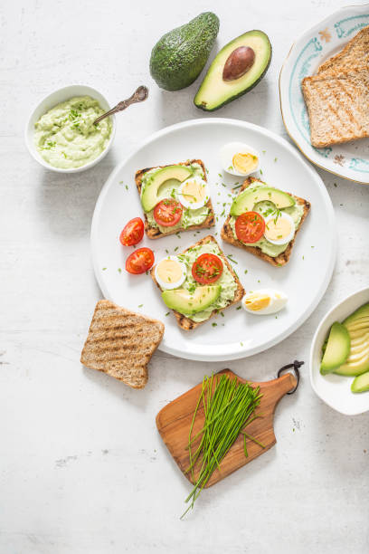 istock Healthy breakfast from toasts with avocado spread guacamole egg tomato and chives. 1204666428