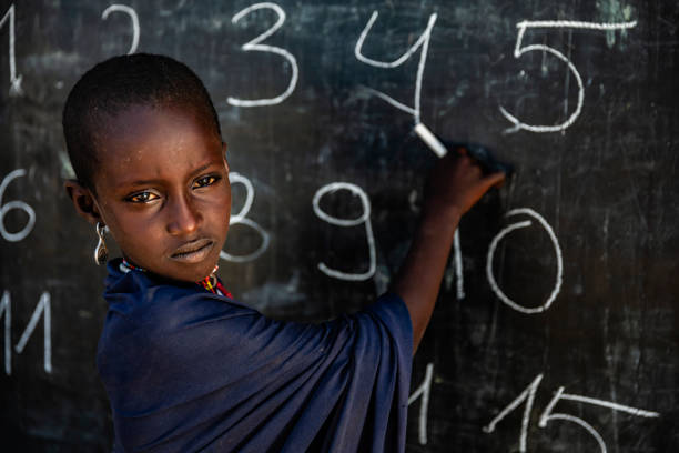 istock African young girl during math class, Arbore tribe, Omo Valley, Ethiopia 1204668208