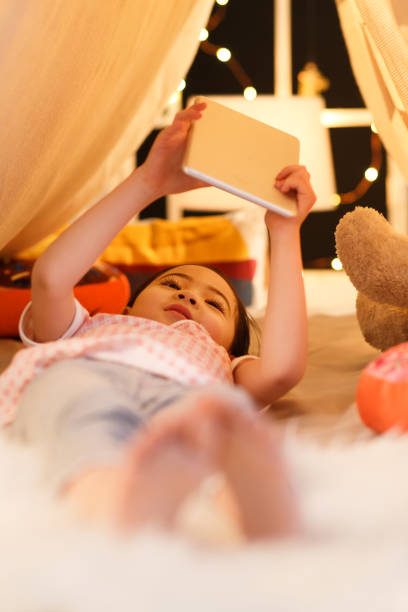 istock Cute little girl looking at Tablet PC 1204669045