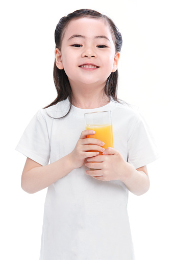 The little girl drinks juice