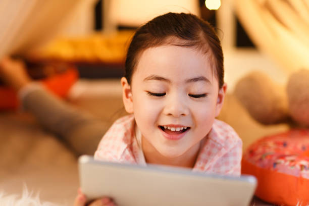 istock Cute little girl looking at Tablet PC 1204671165