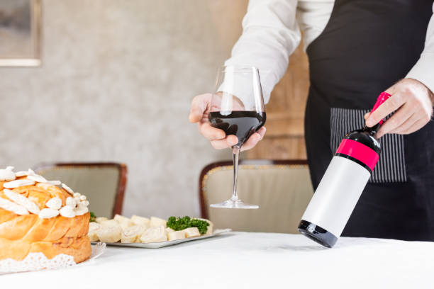 istock Man holding wine and decorated bread on table for celebration a saint in Orthodox faith. Serbian traditional and cultural heritage. 1204671232