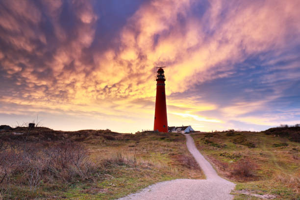 dramatic mammatus clouds over red lighthouse, Schiermonkoog, Holland stock photo