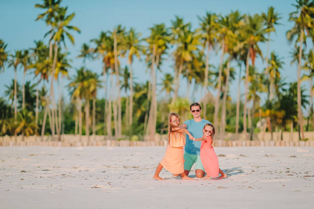 istock Father and little kids on the beach 1204672993