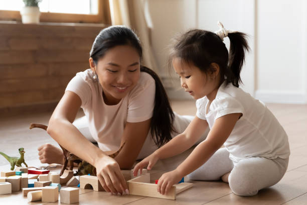 istock Asian young mom and little daughter play building bricks 1204673190