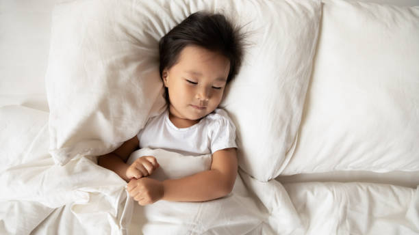 istock Cute little Asian girl relax sleeping in bed 1204673208