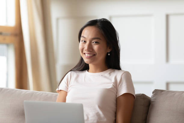 istock Happy Asian girl working browsing web on laptop 1204673268
