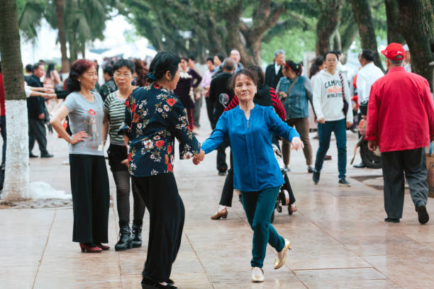 Guilin, China - April 25, 2018: Group of chinese active senior woman dancing in public park.
