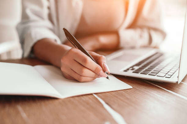istock Freelance woman planning while working on laptop in coffee shop 1204675604