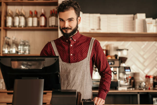 istock Bearded cashier working in cafe 1204675672