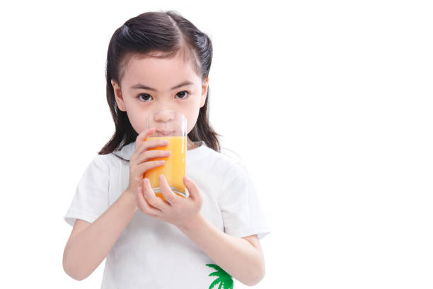 istock The little girl drinks juice 1204675961