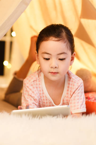 istock Cute little girl looking at Tablet PC 1204676600