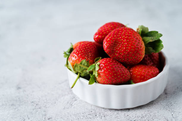 istock Fresh raw red strawberries on a light background 1204676747