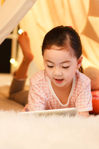 istock Cute little girl looking at Tablet PC 1204676862