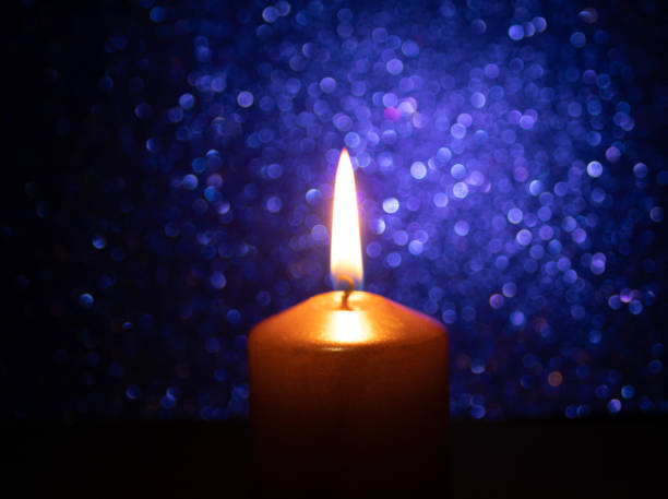 istock Golden candle with bright blue background. background image 1204676927