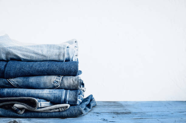 istock Jeans stacked on a wooden table 1204677260