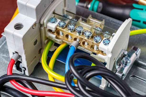 istock Automatic circuit breaker and wire terminal on DIN rail connected by colored wires with cord end insulated ferrules. Assembled electrical panel close-up 1204678059