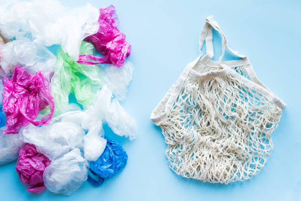 istock Many disposable plastic bags vs one reusable cotton bag 1204678265