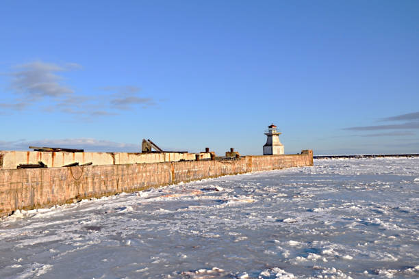 istock Lighthouse on an Abandoned Passenger Ferry Terminal Dock in Winter Cape Tormentine New Brunswick Canada 1204678615