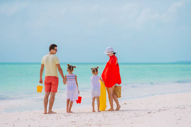 istock Young family on vacation on the beach 1204679802