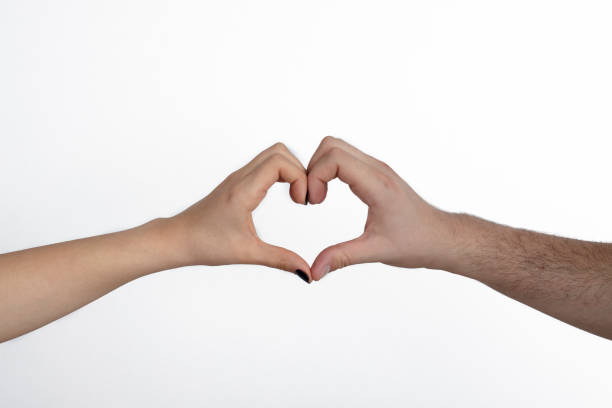 istock Woman and man hands showing heart shape 1204680462