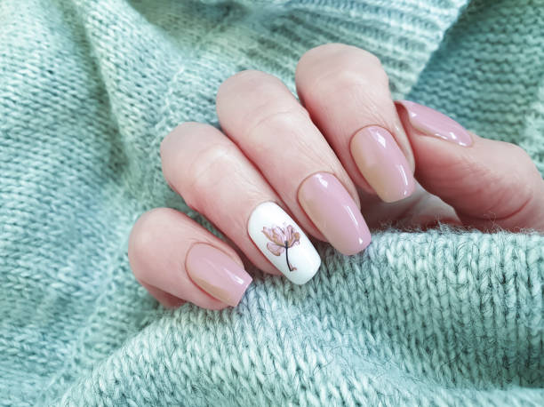 istock female hand beautiful nail manicure sweater 1204681376