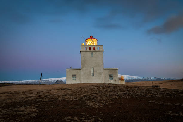 istock Dyrholaey lighthouse over black sand beach in Iceland 1204682656
