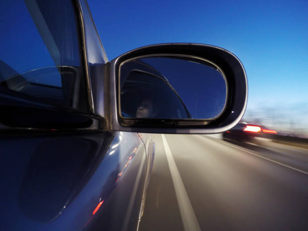 istock Car wing mirror at dusk. Viewed from outside car. 1204685219