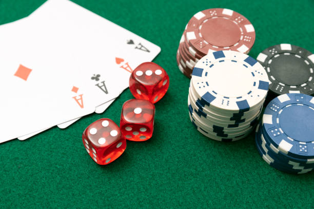 istock Poker chips, cards on green table 1204686219