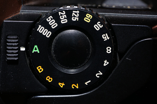 This is a setting wheel for ISO and aperture on an old camera photographed in the studio