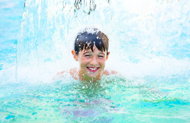istock Child playing in the swimming pool 1204689002