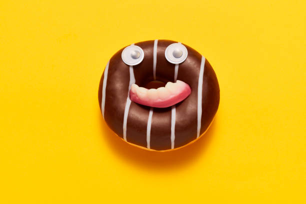 istock Sweet chocolate donut with funny face 1204690314